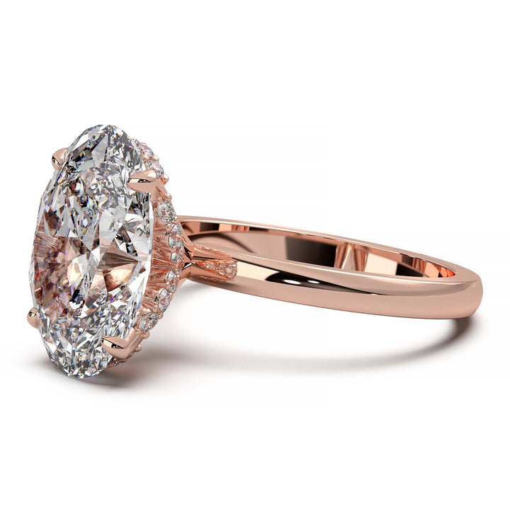 Oval lab-grown diamond engagement ring with hidden halo and low-profile setting.