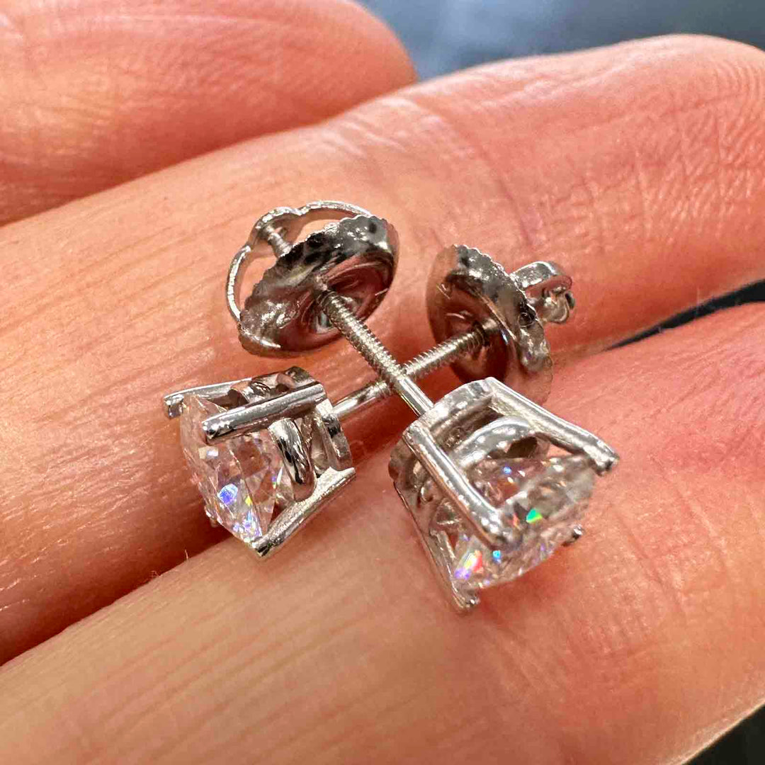 14K white gold stud earrings with 5.5mm colorless moissanite stones and secure screw-back closures, elegant and timeless design.