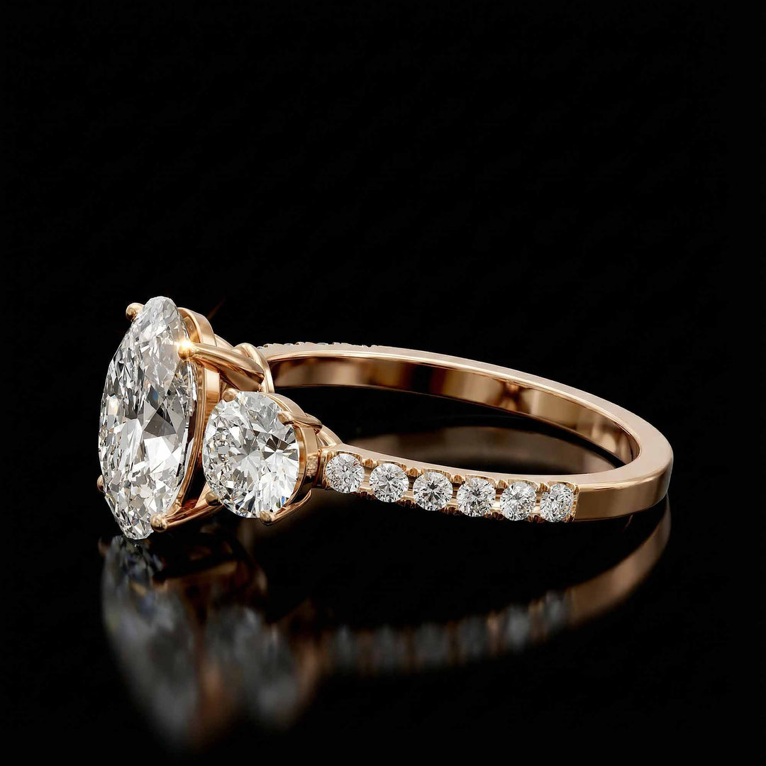 Oval diamond three stone engagement ring with round side stones and pavé band on display.
