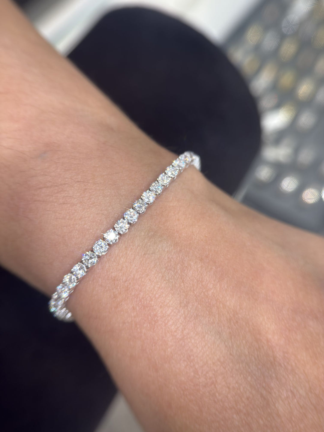 Round lab-grown diamond tennis bracelet on a man’s wrist, second view