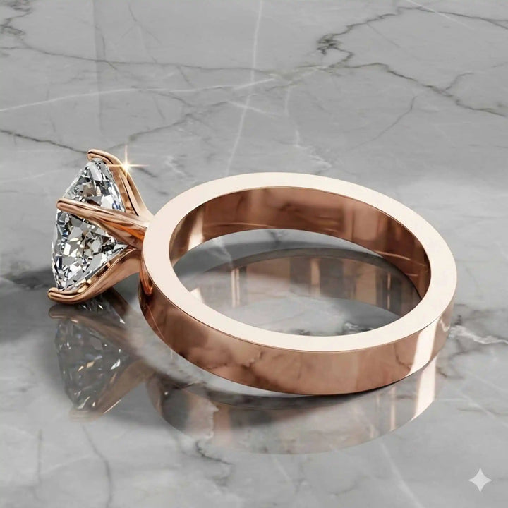 Elongated cushion lab grown diamond solitaire ring on wide flat band shown on display.