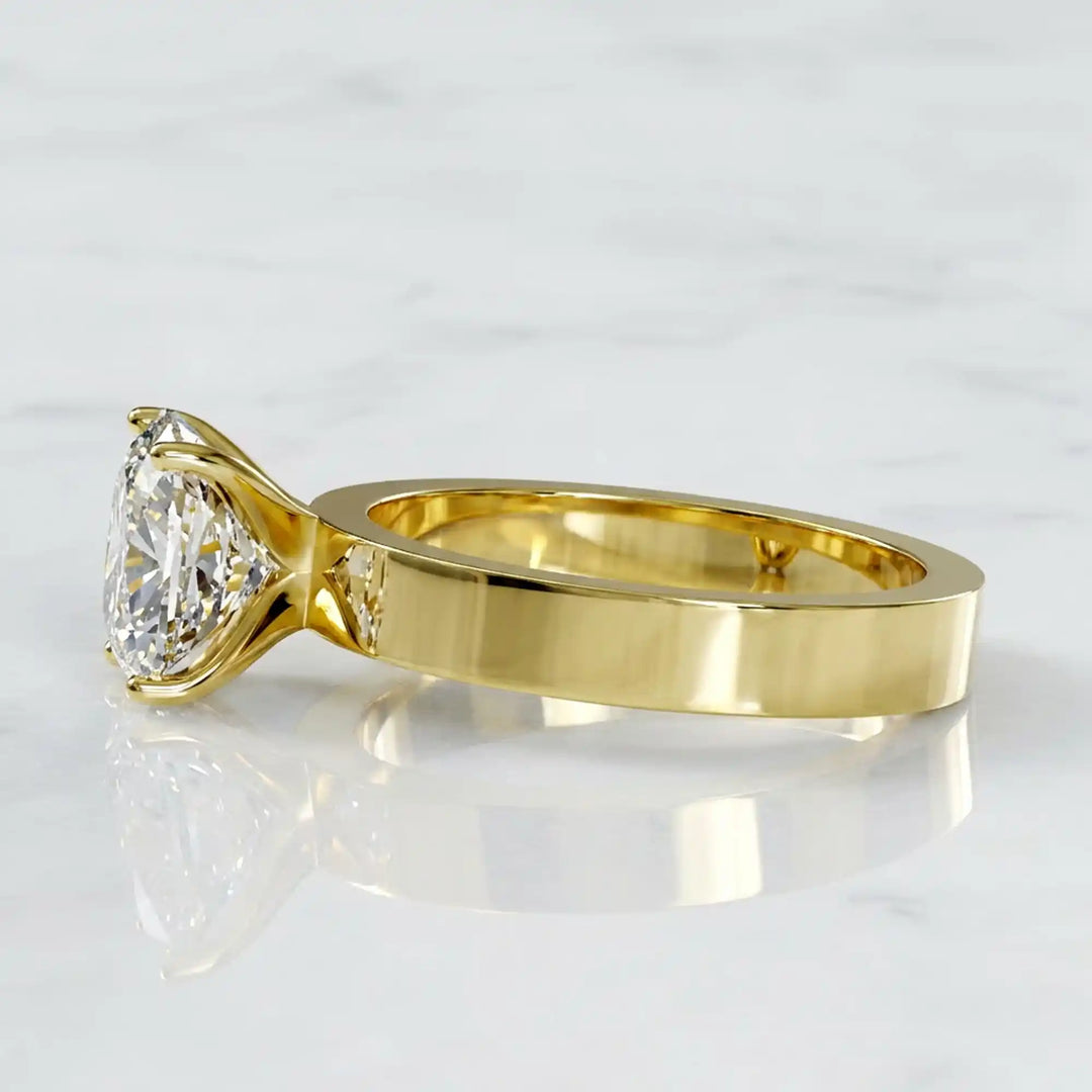 Elongated cushion lab grown diamond solitaire ring on wide flat band shown on display.