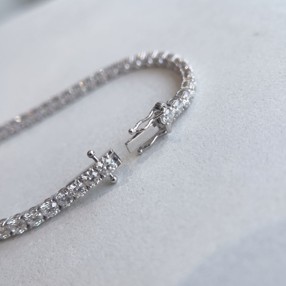 Open tennis bracelet with clasp detail, studio view