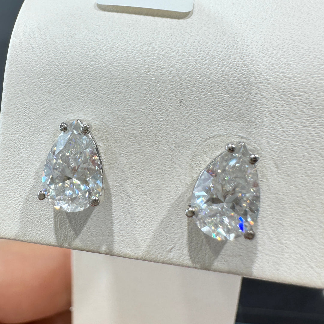 14K white gold stud earrings with 9x5 mm pear-shaped colorless moissanite stones, elegant and timeless design.