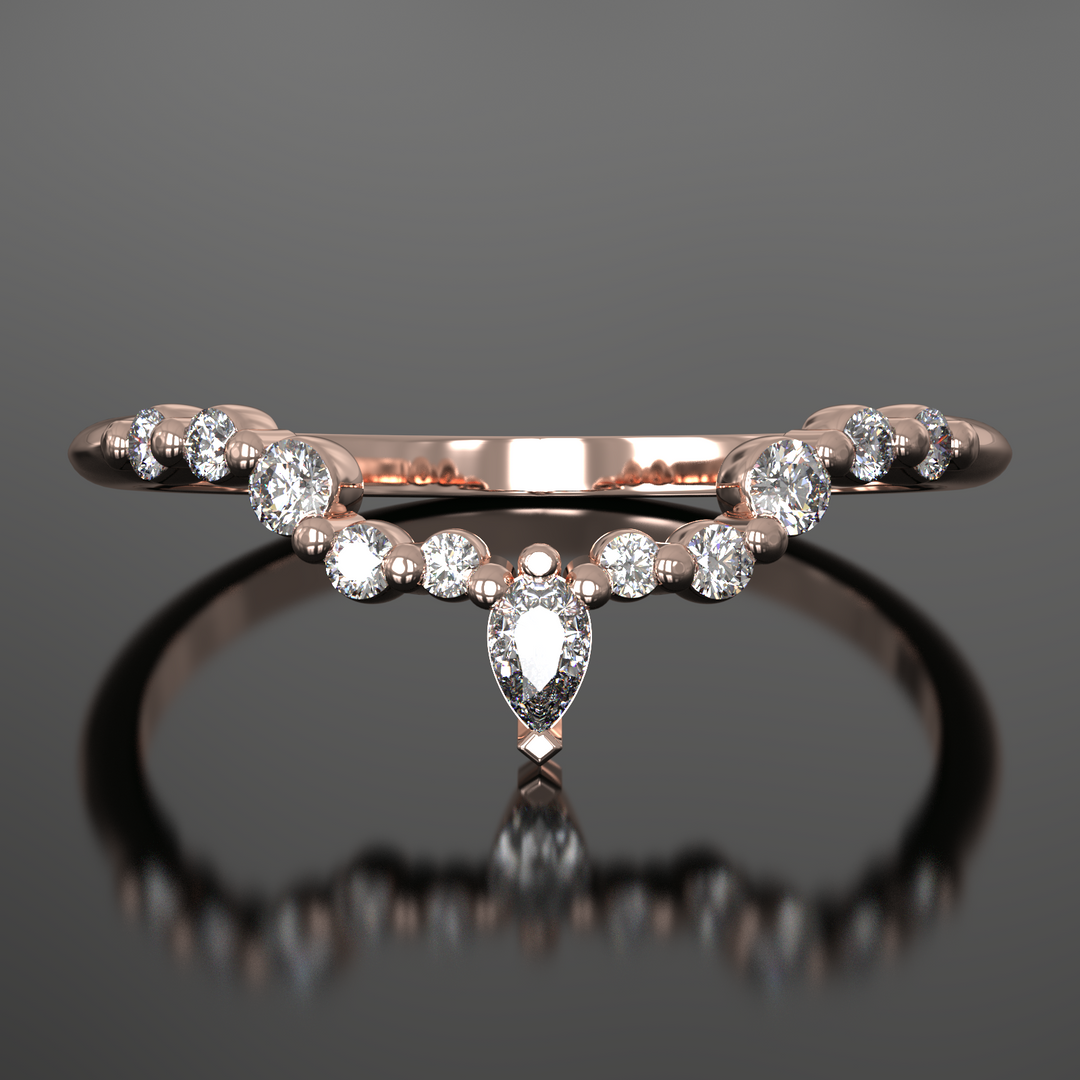 V-shaped wedding band with floating pear and round lab-grown diamonds in a shared prong setting.