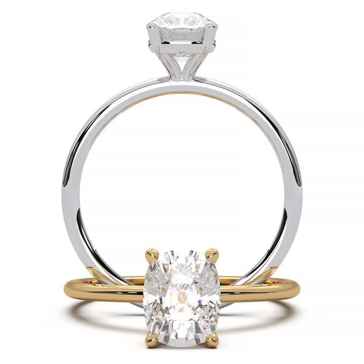 Gold engagement ring featuring a cushion-cut diamond in a four-prong setting.