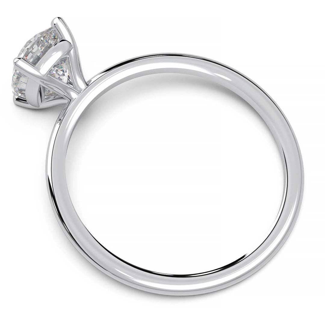 Gold engagement ring featuring a cushion-cut diamond in a four-prong setting.