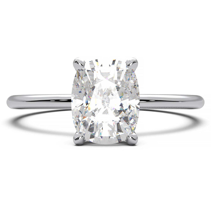 Gold engagement ring featuring a cushion-cut diamond in a four-prong setting.