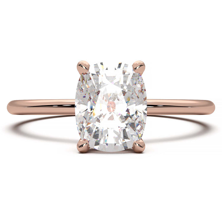 Gold engagement ring featuring a cushion-cut diamond in a four-prong setting.