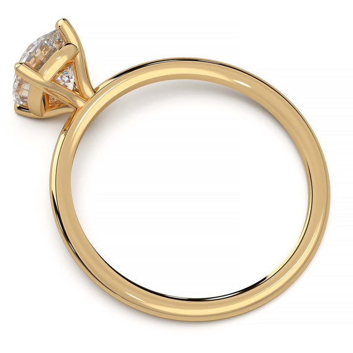 Gold engagement ring featuring a cushion-cut diamond in a four-prong setting.