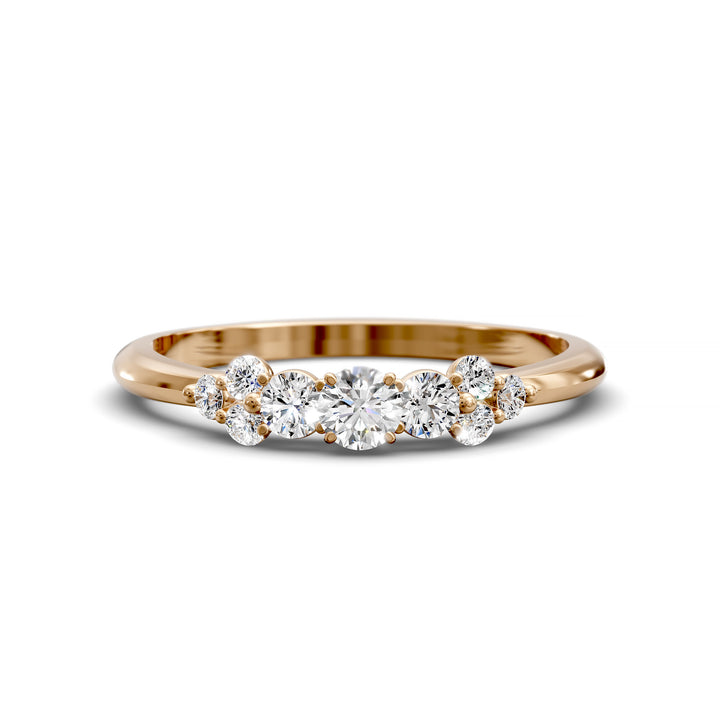 Dainty cluster diamond wedding band with floral-inspired design and tapered band
