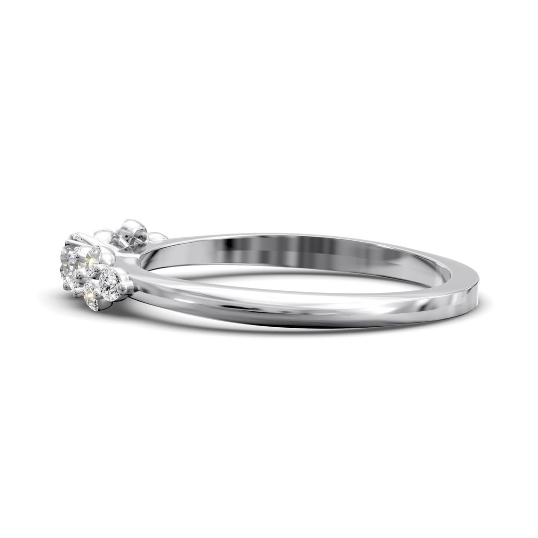 Dainty cluster diamond wedding band with floral-inspired design and tapered band
