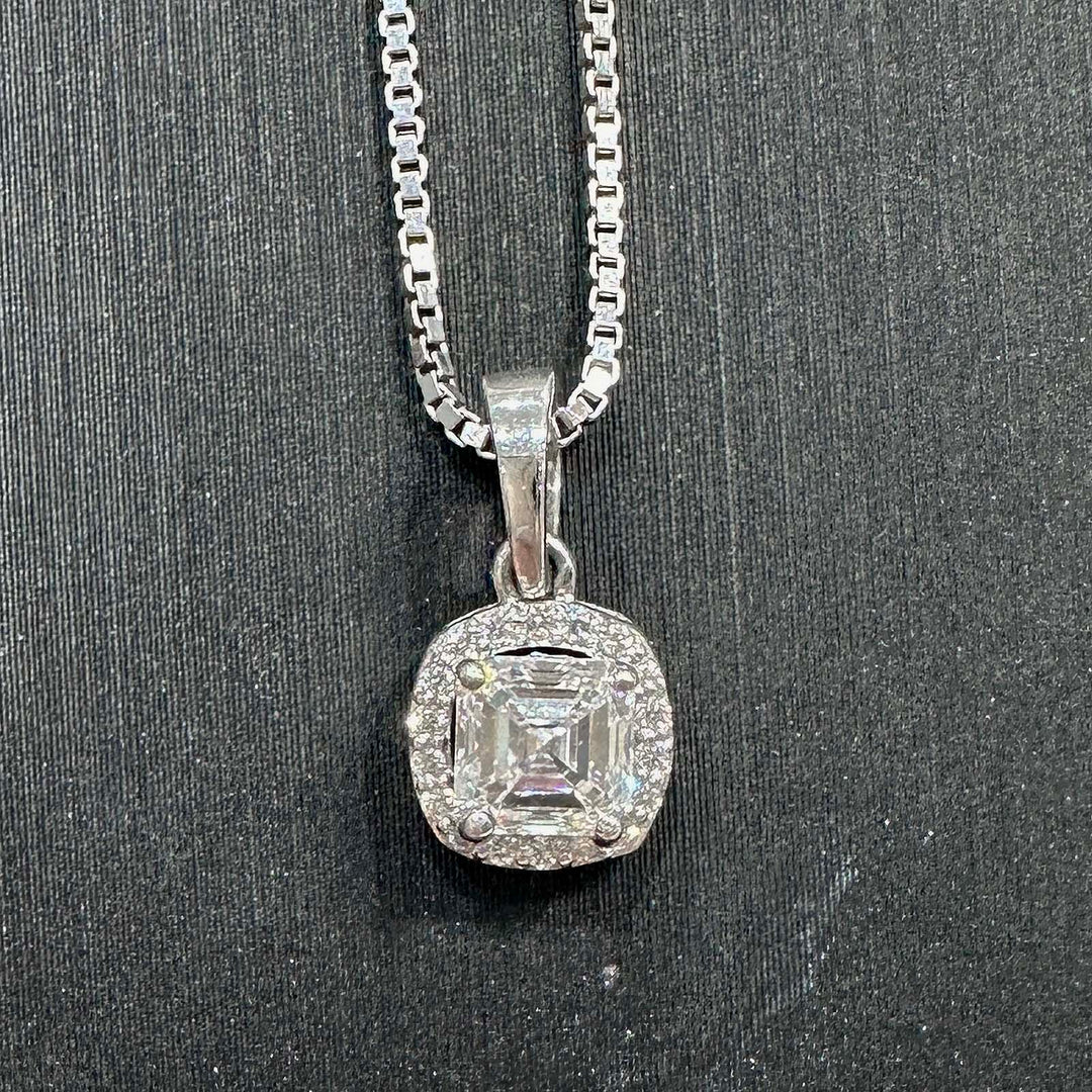 Close-up of a 10K white gold pendant featuring a lab-grown diamond with a delicate diamond halo.