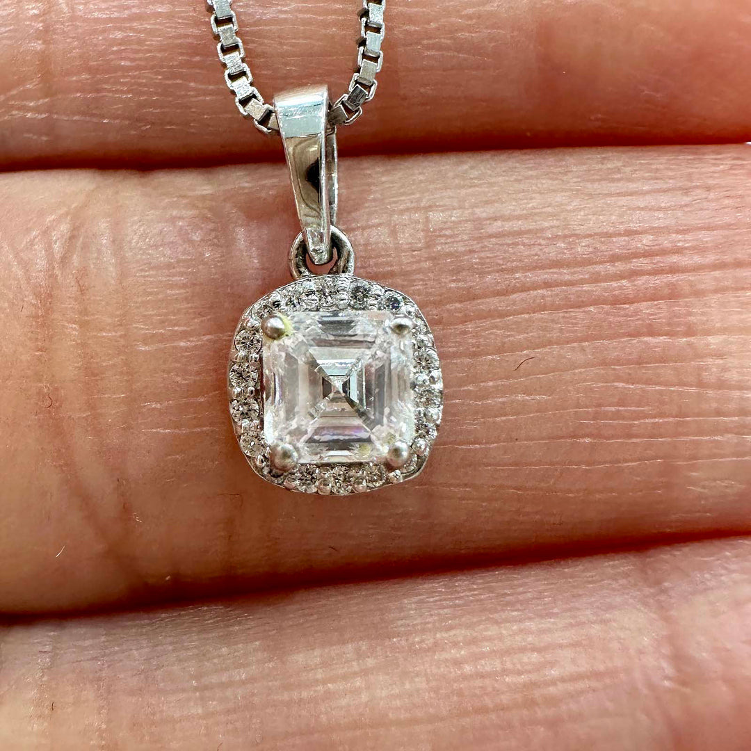 Close-up of a 10K white gold pendant featuring a lab-grown diamond with a delicate diamond halo.