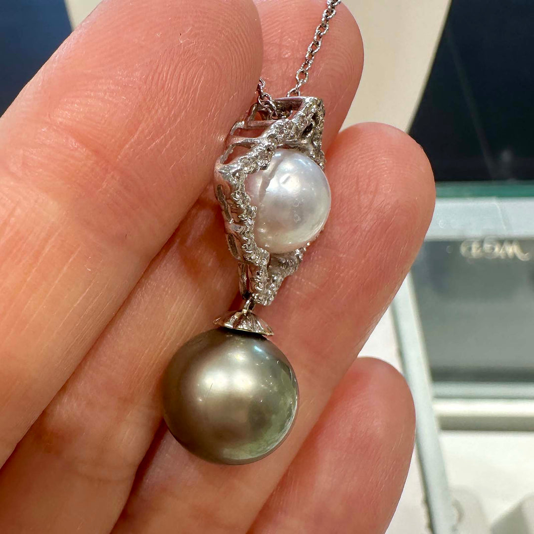 Dual pearl pendant with a light green 10.6mm Tahitian pearl and an 8.5mm white South Sea pearl set in 18K white gold with natural diamonds.