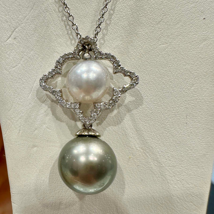 Dual pearl pendant with a light green 10.6mm Tahitian pearl and an 8.5mm white South Sea pearl set in 18K white gold with natural diamonds.