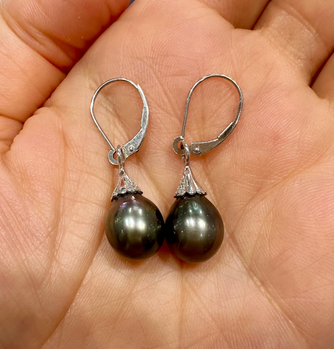 A pair of Tahitian dark green drop-shaped pearl earrings with small diamonds on 14K white gold.