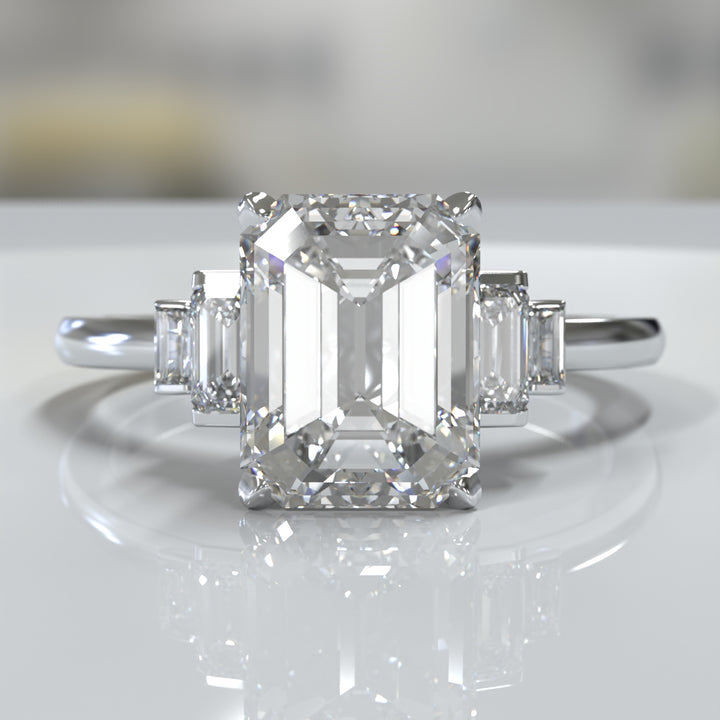 emerald-cut five-stone engagement ring with tapered baguette side diamonds shown from multiple angles