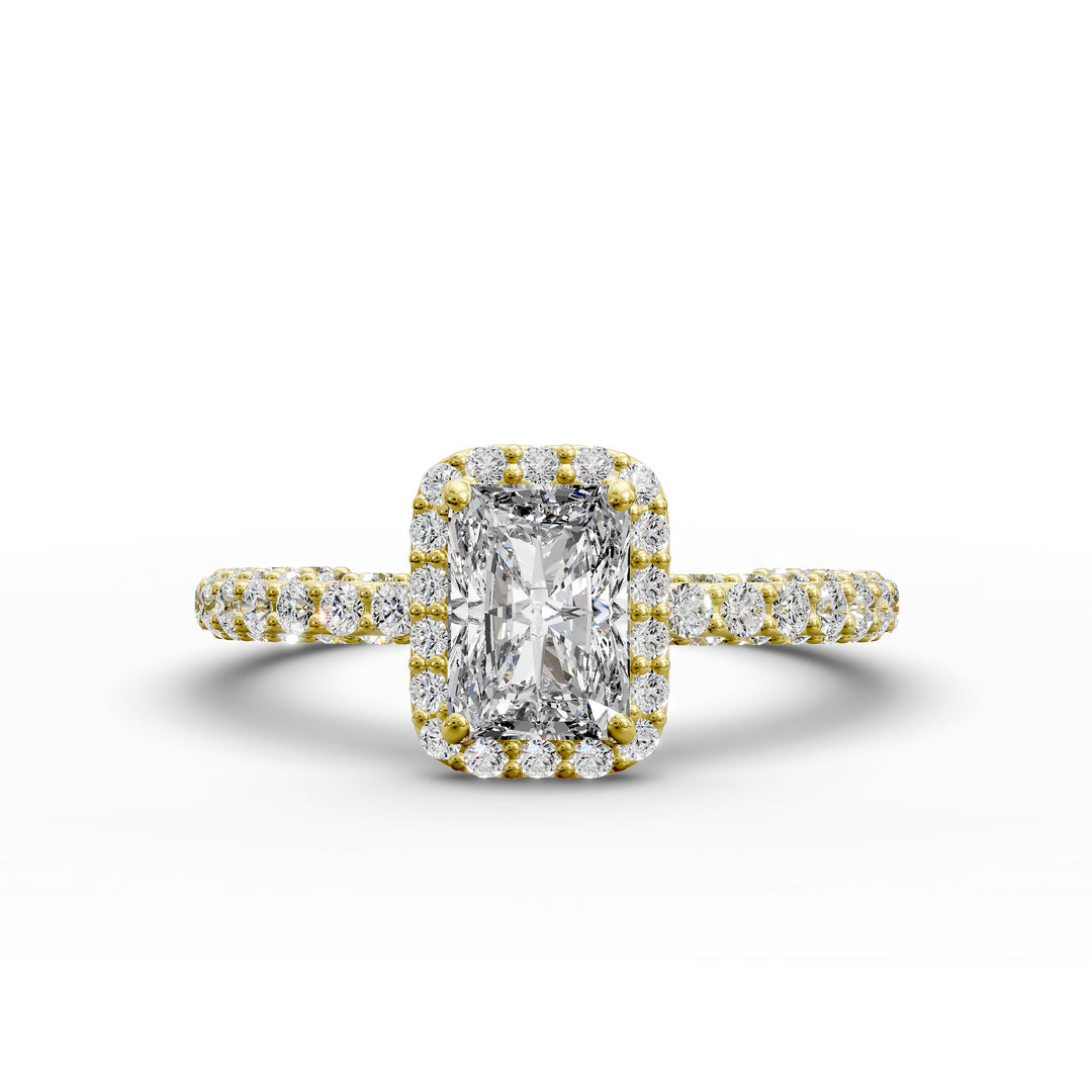 Emerald-cut diamond halo engagement ring with triple prong-set diamond band shown in display view.