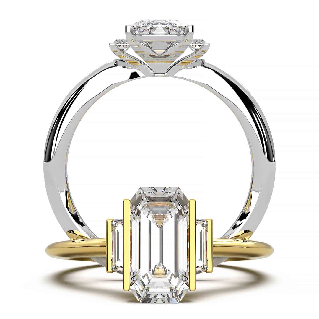 Three-stone engagement ring with emerald-cut diamond, baguette side stones, and modern bar prong setting.