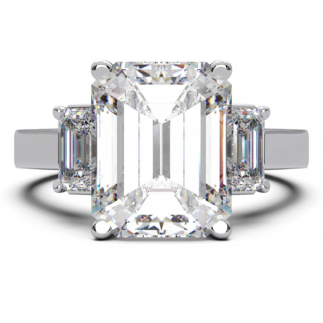 Three-stone engagement ring with 3.5 carat emerald cut lab-grown diamond center and emerald cut side stones.