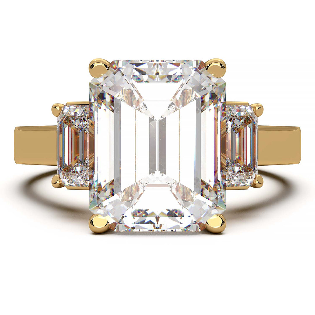 Three-stone engagement ring with 3.5 carat emerald cut lab-grown diamond center and emerald cut side stones.