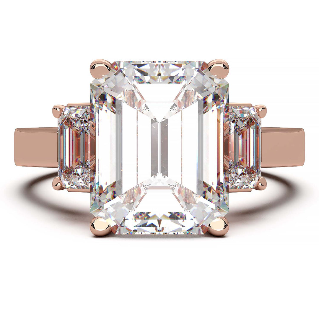 Three-stone engagement ring with 3.5 carat emerald cut lab-grown diamond center and emerald cut side stones.