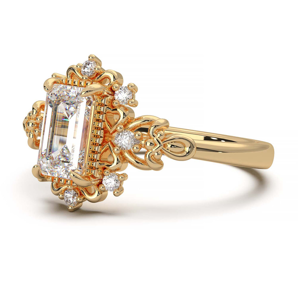 Vintage engagement ring with emerald cut diamond and filigree details.
