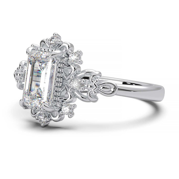 Vintage engagement ring with emerald cut diamond and filigree details.