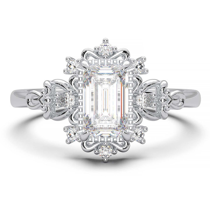 Vintage engagement ring with emerald cut diamond and filigree details.