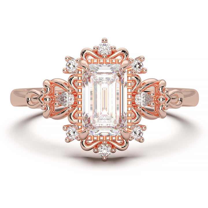 Vintage engagement ring with emerald cut diamond and filigree details.