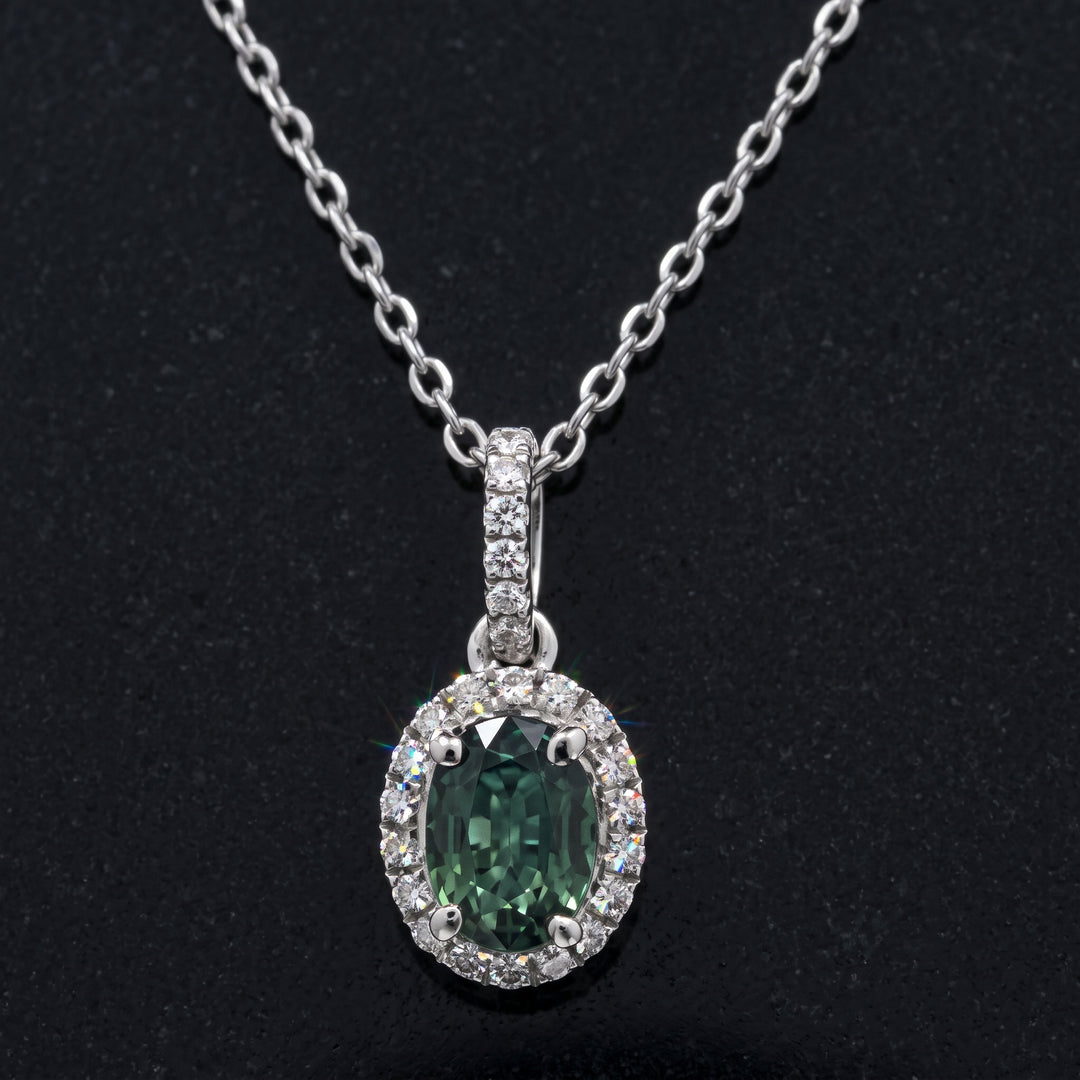 Natural oval green sapphire pendant with diamond halo in 14k white gold, 1.06ct sapphire with 0.23ct diamonds.