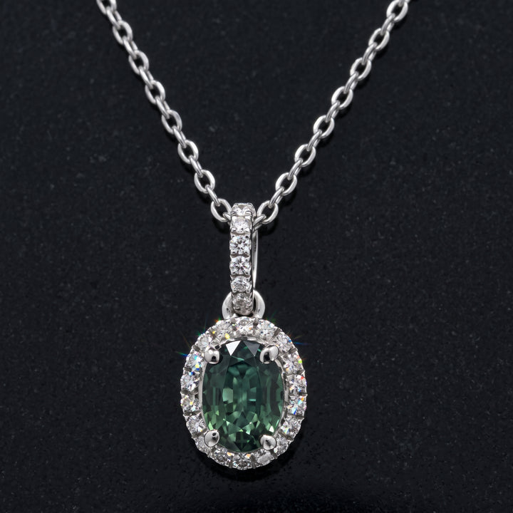 Natural oval green sapphire pendant with diamond halo in 14k white gold, 1.06ct sapphire with 0.23ct diamonds.