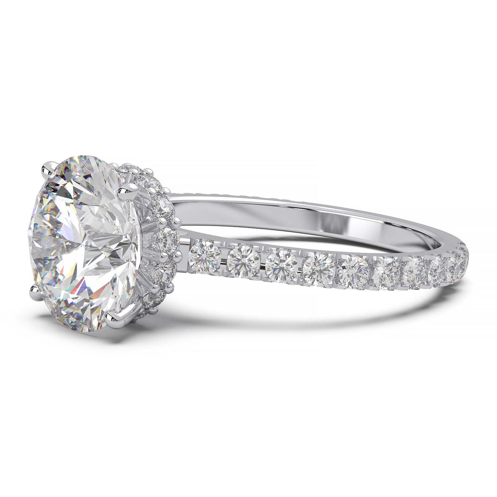 Round lab grown diamond ring with hidden halo, cathedral setting, and pave-set band.