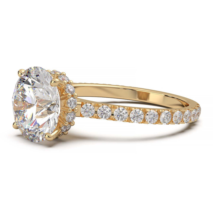 Round lab grown diamond ring with hidden halo, cathedral setting, and pave-set band.