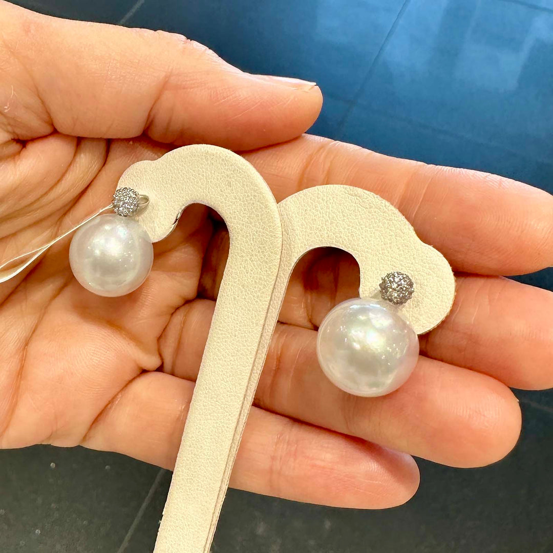 South Sea pearl stud earrings with 14.2mm white pearls, 18K white gold, and 0.28 ct natural diamonds.