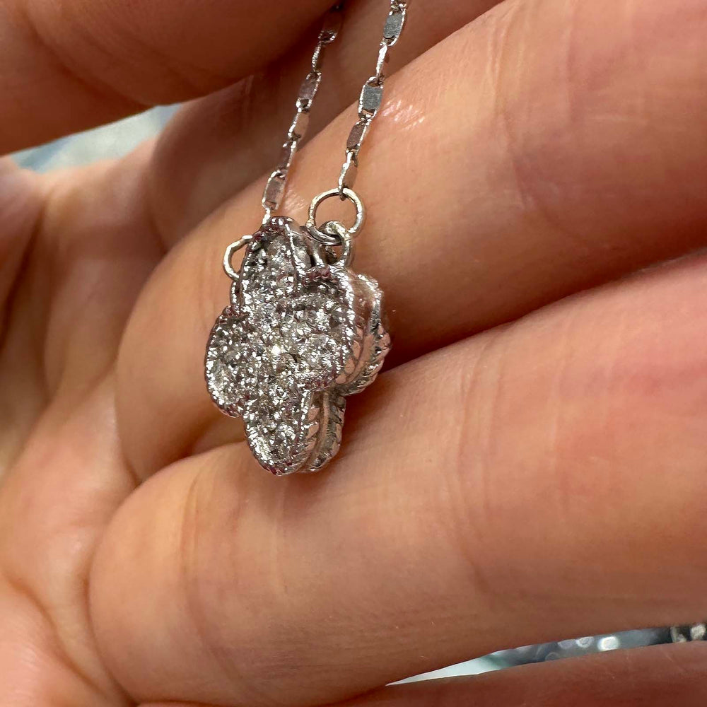 Close-up of a 14K white gold cluster necklace with 0.55ct lab diamonds in a four-leaf clover design.