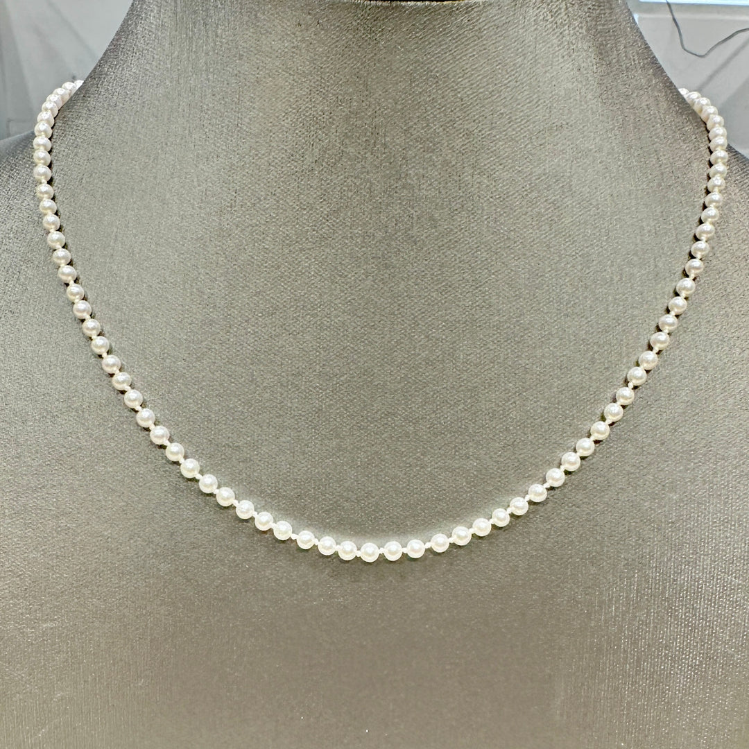 Delicate freshwater pearl necklace with 3.1mm round white pearls, 21 inches long, featuring a 14k yellow gold fish clasp.