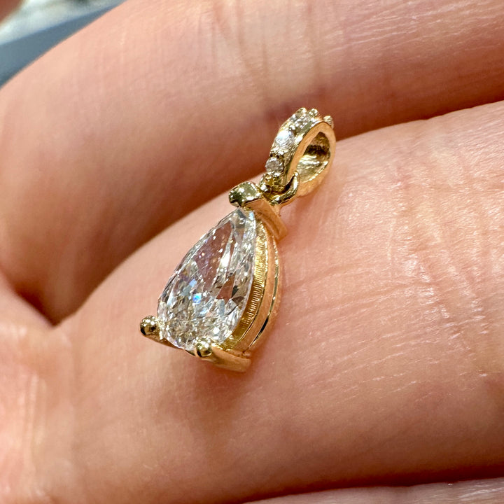 Pear-shaped diamond pendant in 14K yellow gold with 0.47 ct center stone, G color, SI2 clarity, and diamond-adorned bale.