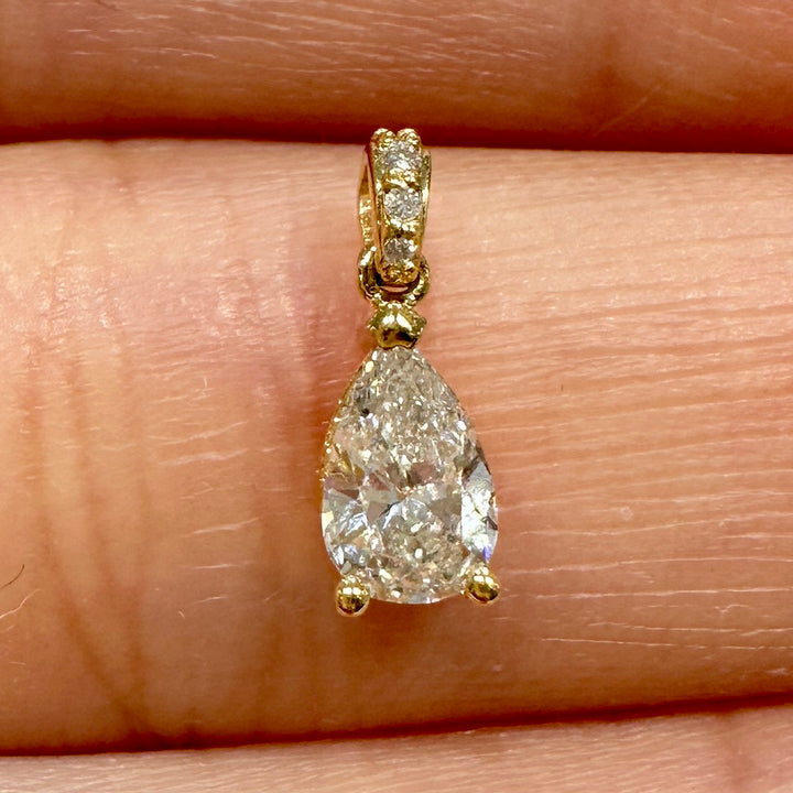 Pear-shaped diamond pendant in 14K yellow gold with 0.47 ct center stone, G color, SI2 clarity, and diamond-adorned bale.