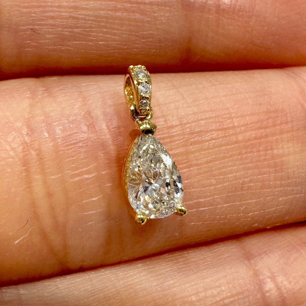 Pear-shaped diamond pendant in 14K yellow gold with 0.47 ct center stone, G color, SI2 clarity, and diamond-adorned bale.