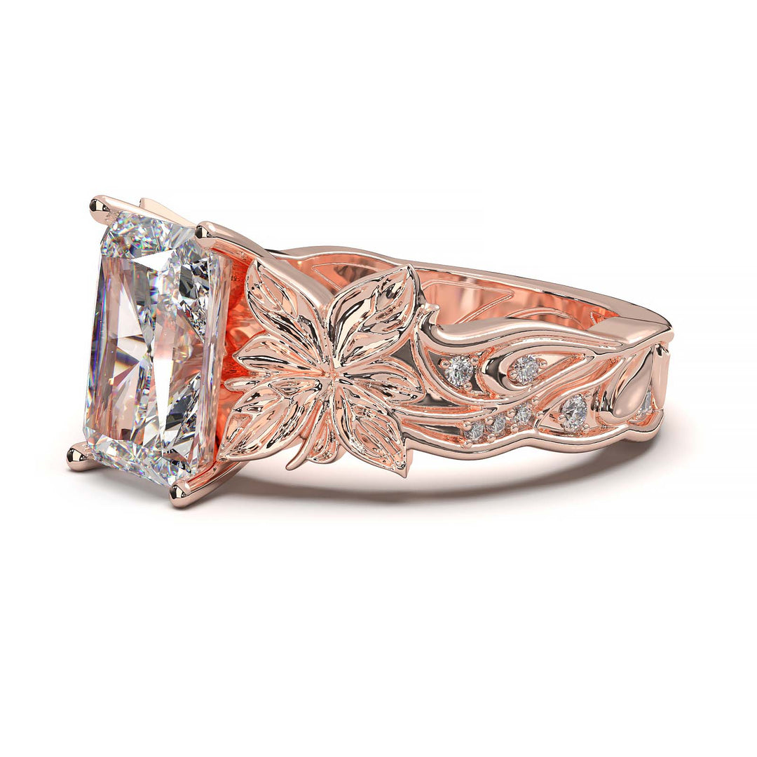 Radiant cut diamond engagement ring with floral leaf design.