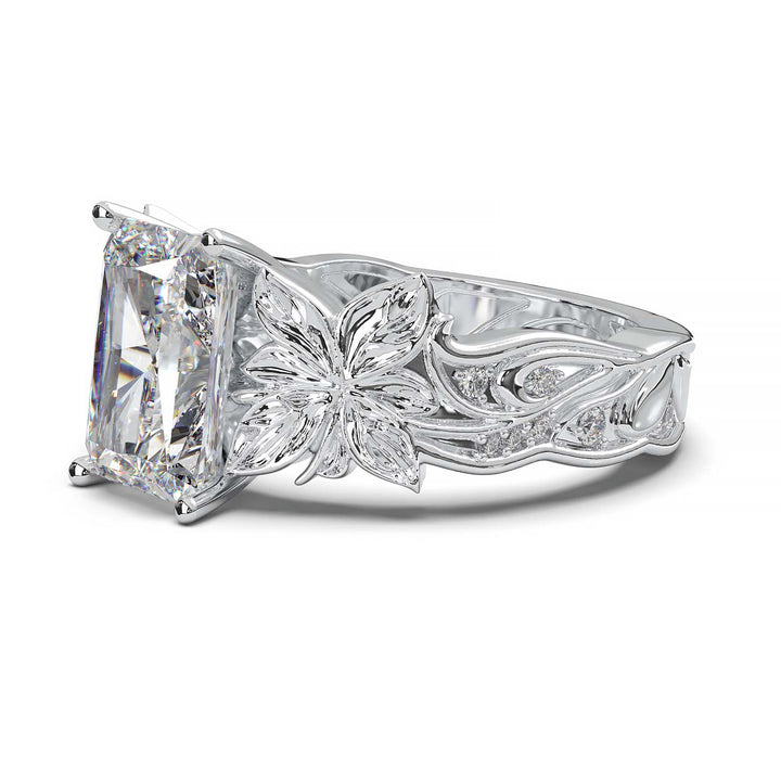 Radiant cut diamond engagement ring with floral leaf design.