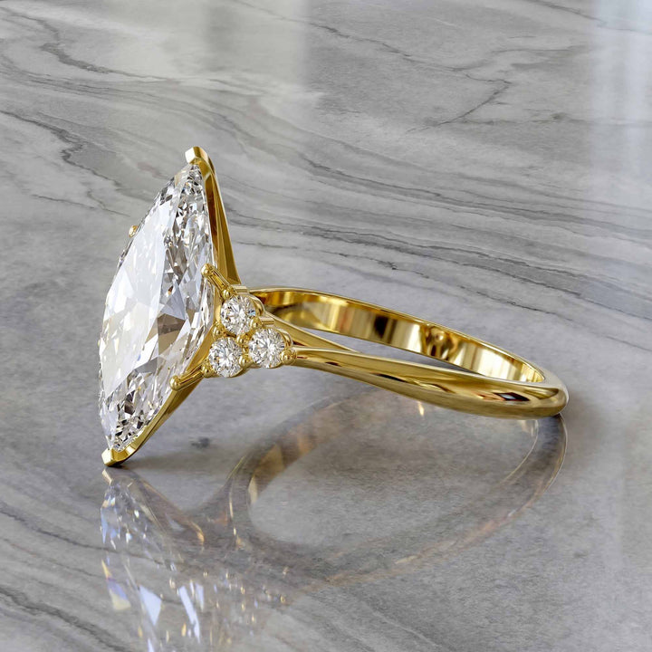 Marquise diamond engagement ring with clustered side diamonds.
