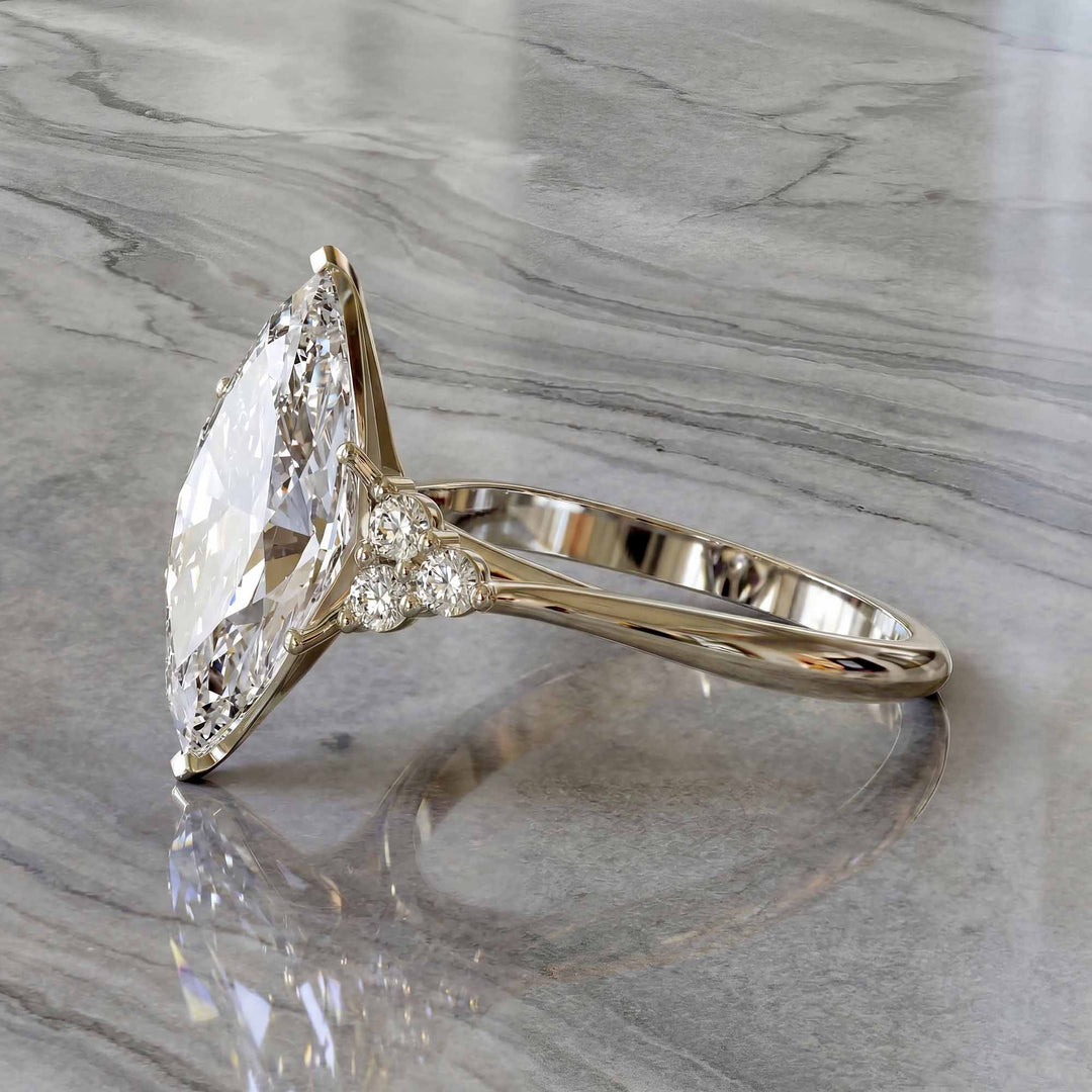 Marquise diamond engagement ring with clustered side diamonds.
