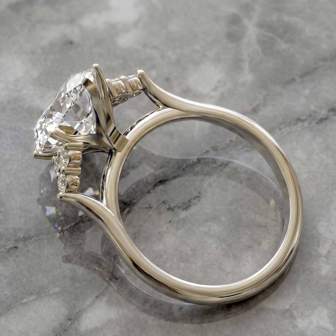 Marquise diamond engagement ring with clustered side diamonds.
