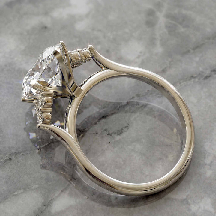 Marquise diamond engagement ring with clustered side diamonds.
