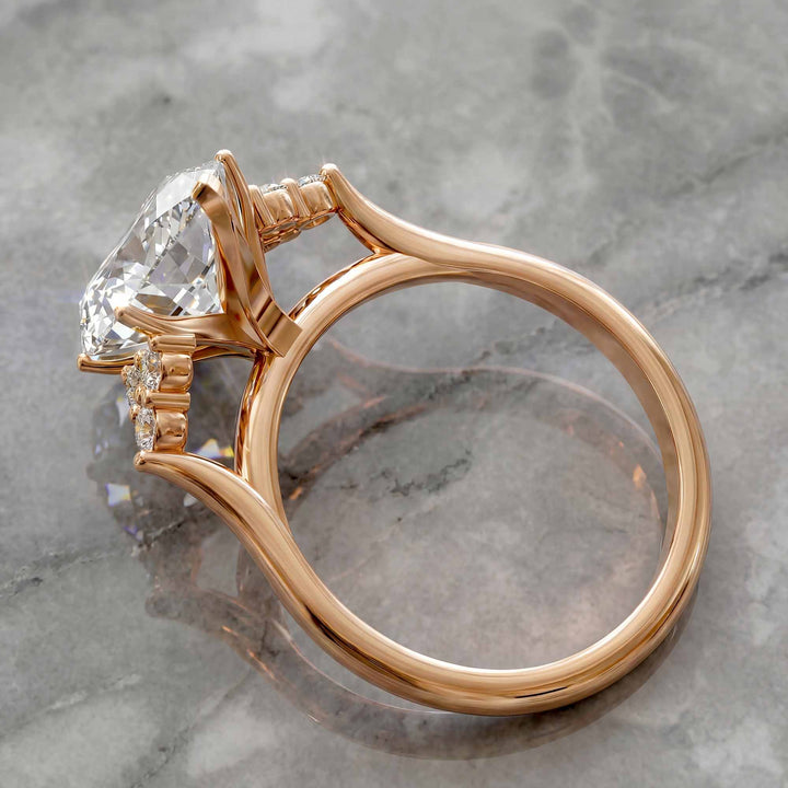 Marquise diamond engagement ring with clustered side diamonds.
