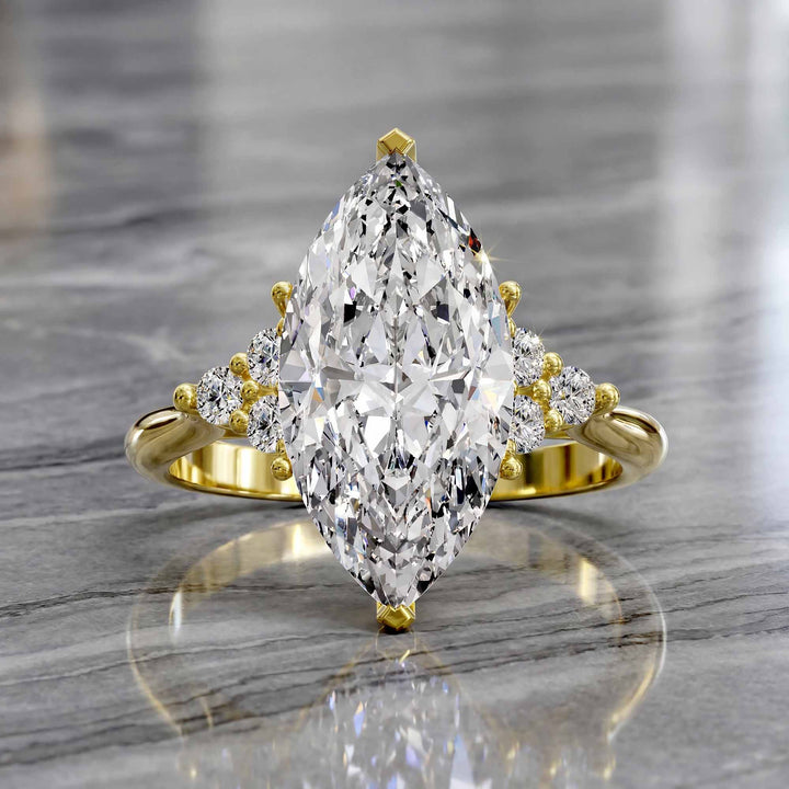 Marquise diamond engagement ring with clustered side diamonds.
