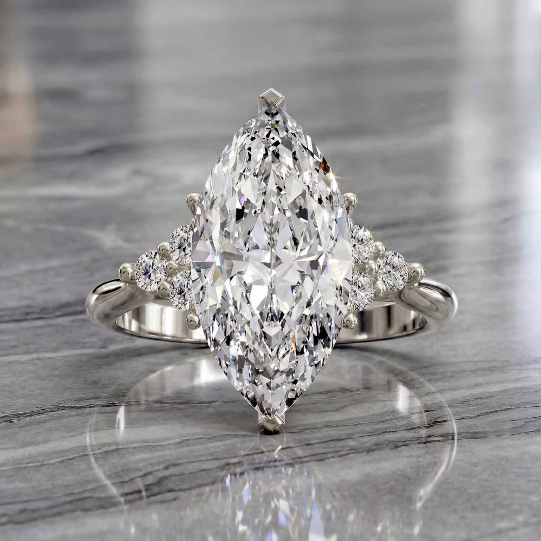 Marquise diamond engagement ring with clustered side diamonds.
